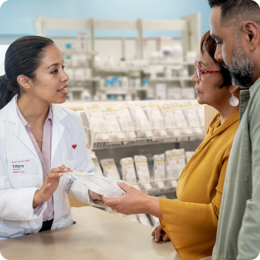 man and woman speaking to pharmacist