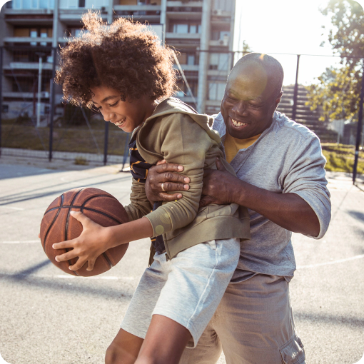 Father and son playing basketball