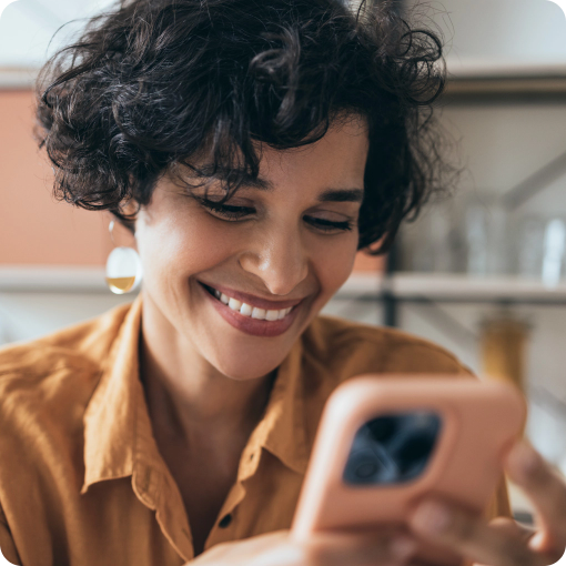 Woman looking at phone smiling