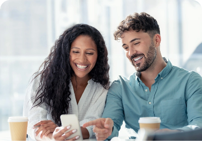 man and woman looking at phone